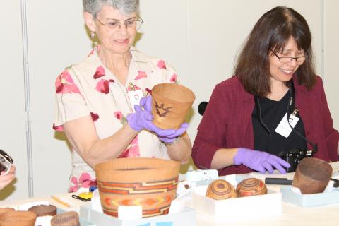 Marjorie Peterson and Daphne Wright Looking at Baskets