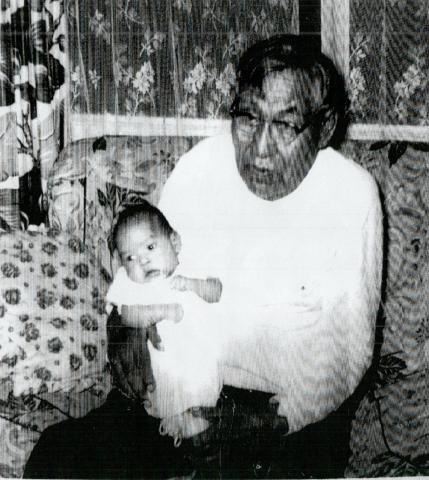 Frank St. Clair Holding a Baby