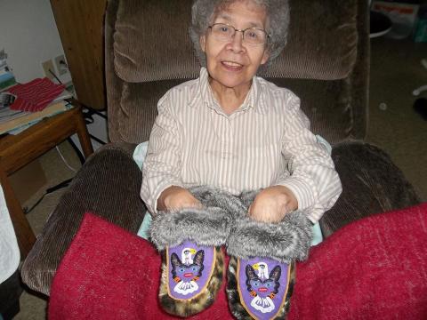 Ruth James Holding Moccasins she Made