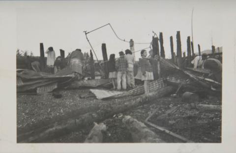 Children and Adults Looking Through Fire Remnants