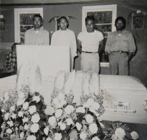 James Lindoff, Sr., Wilbur Lindoff, George Mayeda and Walter Lindoff, Sr. standing behind a casket. 