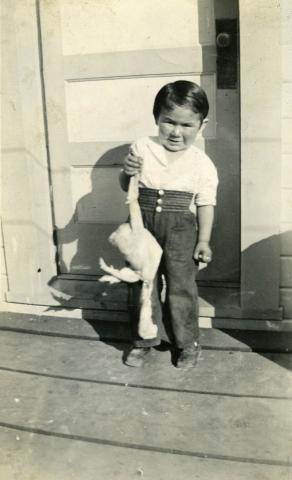 Bill Wolfe, Sr. as a Young Boy holding a Chicken